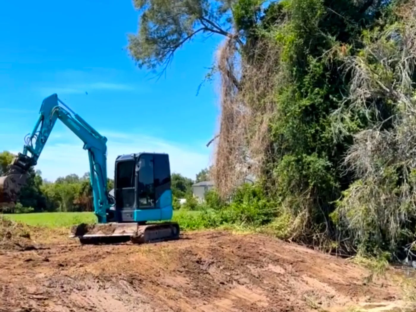 Excavator on a creek bank — Noosa hinterland, by Adams Earthworx