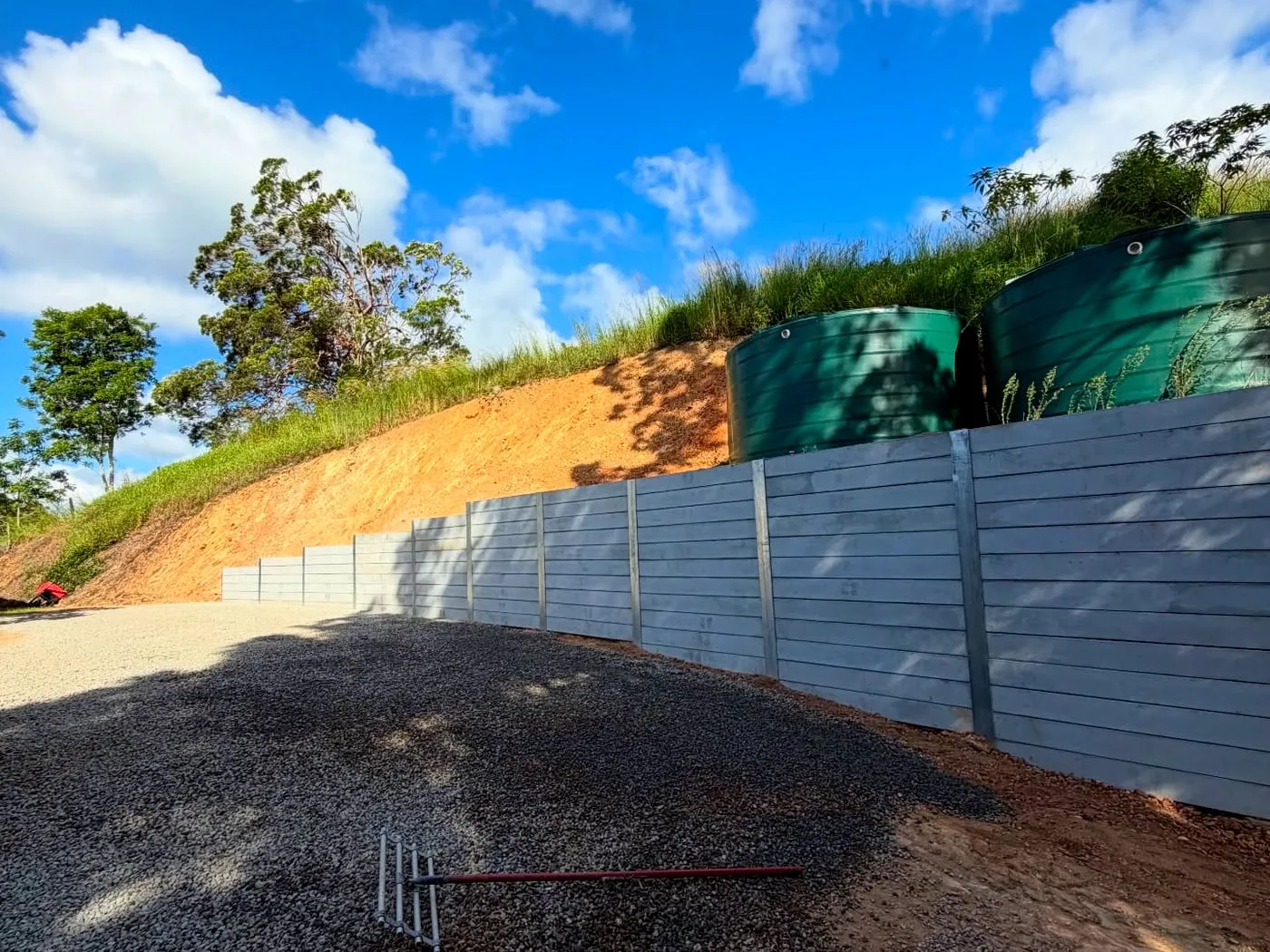 Retaining wall & water tanks on a slope — Noosa hinterland, by Adams Earthworx