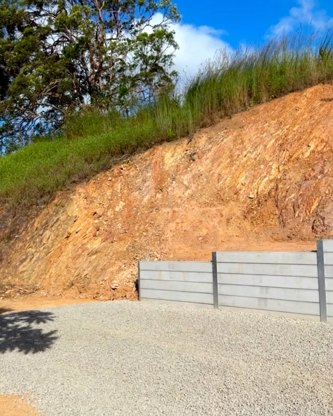 Sleeper wall holding a steep cut — Noosa hinterland, by Adams Earthworx